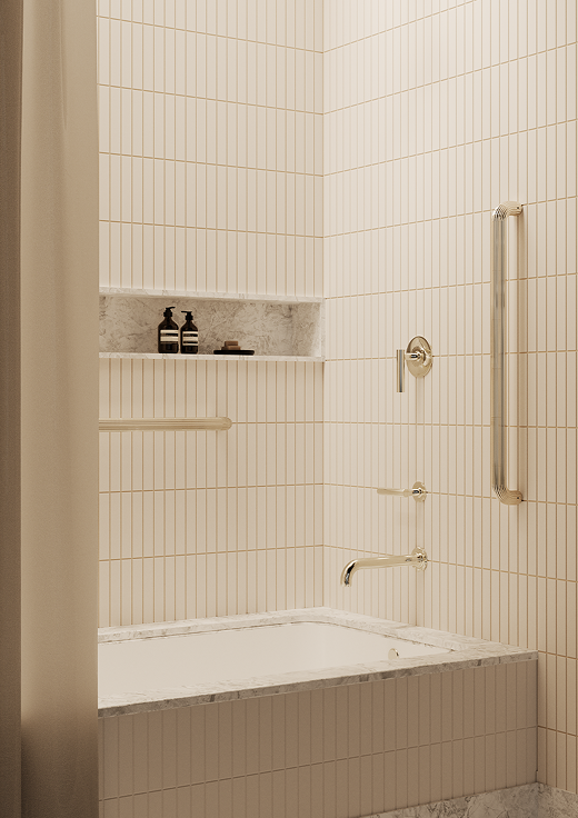 Refined soaking tub surround in vertical white tile with polished nickel fixtures, marble ledge, and built-in niche — elegant, low-threshold bathtub design