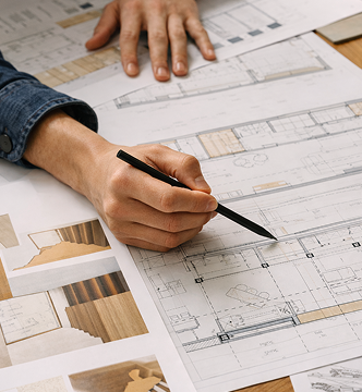 Interior designer reviewing custom bathroom blueprints and material samples — personalized bathroom design consultation and renovation planning