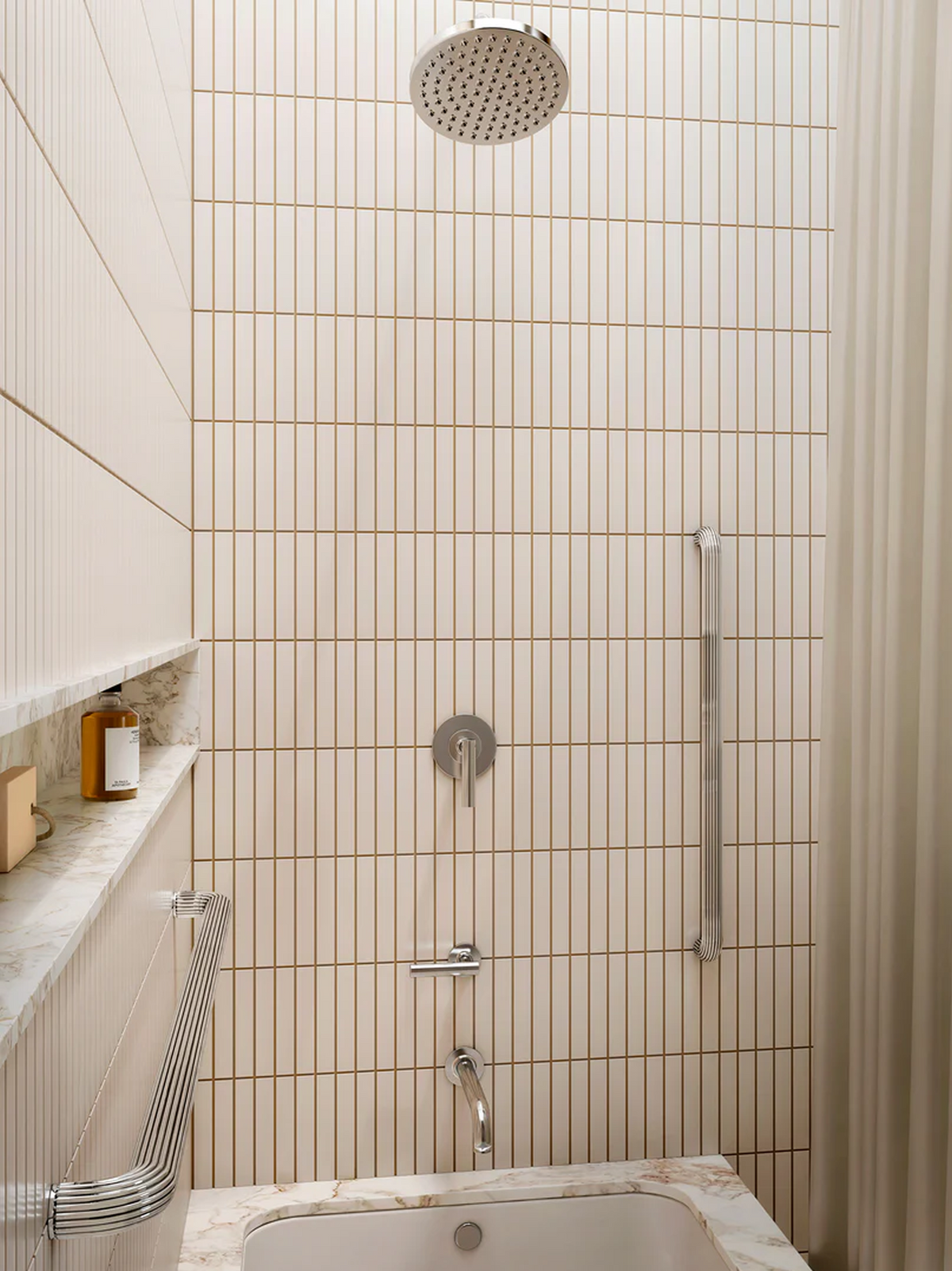 A modern bathroom shower area with beige vertical subway tiles, a round silver shower head, chrome fixtures, a marble ledge with a small bottle, and a cream shower curtain featuring prominently the grab bars by REMSEN.